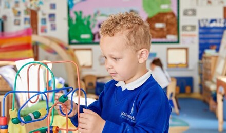 Child playing with toys in nursery