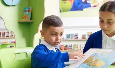 Two children sharing a reading book