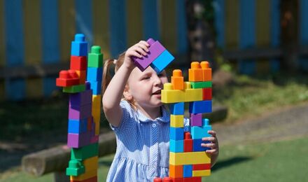 A child making a tower in nursery