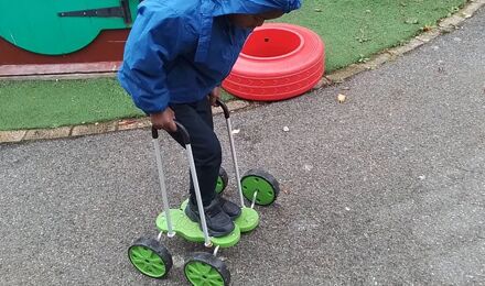 Child playing outdoors in nursery