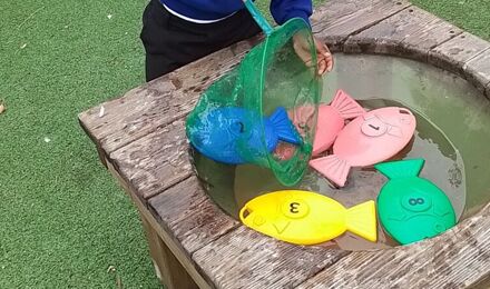 Nursery child playing a fishing game